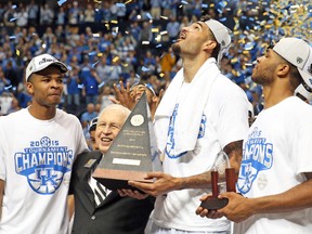 Kentucky’s Willie Cauley-Stein celebrates with the trophy on the court after winning the SEC title game yesterday in Nashville. (AFP)
