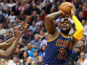 LeBron James of the Cleveland Cavaliers takes a shot against the Dallas Mavericks at American Airlines Center on March 10, 2015. (Ronald Martinez/Getty Images/AFP)