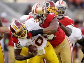 Robert Griffin III #10 of the Washington Redskins is sacked by Ray McDonald #91 of the San Francisco 49ers in the first half at Levi's Stadium on November 23, 2014 in Santa Clara, California. (Ezra Shaw/Getty Images/AFP)