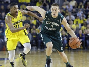 Brandon Nazione of the Eastern Michigan Eagles drives to the basket against Zak Irvin of the Michigan Wolverines during the second half at Crisler Arena on December 9, 2014. (Duane Burleson/Getty Images/AFP)