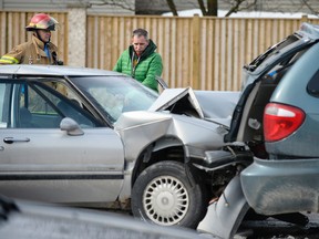 The father of a driver involved in a multi-vehicle crash surveys the damage to a vehicle while talking to emergency service workers at the scene of the crash. A call came in around 11:30 a.m. for the crash at the intersection of Highbury Ave. and Killarney Rd. in London. (ANDREW LAHODYNSKYJ/ special to The London Free Press /QMI AGENCY)