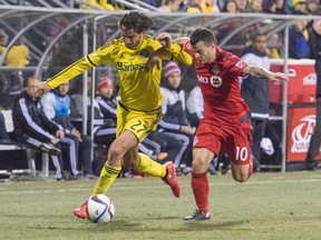 Columbus Crew defender Hernan Grana (27) and Toronto FC midfielder Sebastian Giovinco (10) fight for the ball in the second half of the game at Mapfre Stadium. The Columbus Crew beat Toronto FC by the score of 2-0. (Trevor Ruszkowski-USA TODAY Sports)
