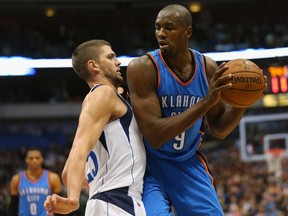 Serge Ibaka of the Oklahoma City Thunder is guarded by Chandler Parsons of the Dallas Mavericks at American Airlines Center on December 28, 2014. (Ronald Martinez/Getty Images/AFP)