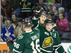 London Knights forward Mitch Marner high-fives teammate Max Domi after scoring a goal against the Windsor Spitfires during their OHL junior hockey regular season game at Budweiser Gardens in London on Friday January 16, 2015. (CRAIG GLOVER, The London Free Press)