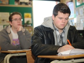 Mitchell Stewart, 17, sits behind Brody Dubord,17, during an exam review in their Grade 12 social studies class at Composite High School. Grade 12 students from around the city will be writing their provincial diploma exams this week - they account for 50 per cent of their final grade. "I don't approve, it's too much pressure," Dubord said. On Monday, Jan. 13, 2014, many  students crammed in some study time during the hectic exam period.  Some students took advantage of their break period to review subjects independently while others had their review during class time. LAURA BOOTH/DAILY HERALD-TRIBUNE/QMI AGENCY