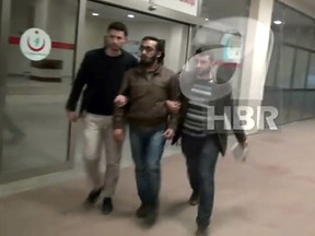 A screen grab from video released by Turkish A Haber news channel shows what is believed to be the Syrian man detained by Turkish authorities on suspicion of helping British girls join ISIS. The man has told his interrogators he was spying for Canada in exchange for eventual Canadian citizenship. (Handout/HBR)
