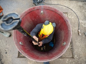 "Fletch" Fletcher, a city water employee, finishes up some work on a frozen pipe at the Byron Community Church. Due to the bone chilling temperatures this winter, the city has been out fixing hundreds of frozen water pipes (ANDREW LAHODYNSKYJ, The London Free Press)