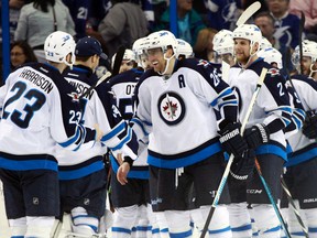 Jets players shake hands with one another after a huge 2-1 win over the Tampa Bay Lightning on Saturday night.