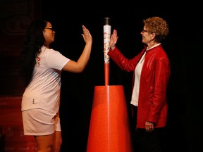 Ontario Premier Kathleen Wynne (R) poses with torch bearer Tanisha Martinez, 22, at the unveiling of the Pan Am Games torch at the  Ontario Science Centre on Monday March 16, 2015. (Jack Boland/Toronto Sun)