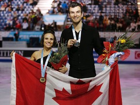 Canadians Meagan Duhamel and Eric Radford pose with their gold medals after winning the final of the ice pairs skating competition at the Grand Prix of Figure Skating in December. (Reuters)