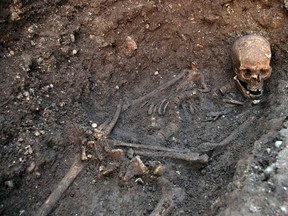 The skeleton of Richard III is seen in a trench at the Grey Friars excavation site in Leicester, central England, in this picture provided by the University of Leicester and received in London on Feb. 4, 2013. (REUTERS/University of Leicester/Handout/Files)