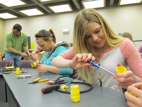 Megan Fleckie, a student at Alexander Mackenzie Secondary School in Sarnia, Ont., is shown in this file photo putting together an extension cord during a Women in Skilled Trades Day held May 8, 2014 at Lambton College. The importance of post-secondary job training and education is highlighted in the results of the Sarnia-Lambton Workforce Development Board's 2015 EmployerOne survey. )File photo/Sarnia Observer/QMI Agency)