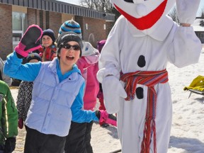 Dayna Vosper (left) poses for a photo with Bonhomme during the annual Winter Carnaval at St. Columban School last Thursday, March 12. KRISTINE JEAN/MITCHELL ADVOCATE