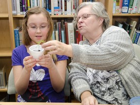 Elaine Kolomeitz from the Cochrane Horticultural Society demonstrates the different sizes and shapes of seeds during Saturday's Garden Magic workshop held at the Cochrane Public Library.