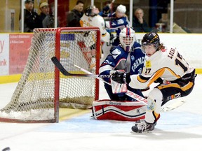 Cochrane Crunch goalie Brett Young and Abitibi Eskimos forward Brenden Locke follow the path of a puck that hopped over Locke’s stick before he could get off a shot during the first period of Game 1 of the NOJHL East Division semifinal series at the Tim Horton Event Centre in Cochrane Thursday night. The Crunch defeated the Eskimos 5-2 to take a 1-0 lead in the series.