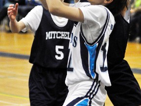 Julia Dixon (15) of the Mitchell Mavericks battles for the loose ball against St. Marys during Huron-Perth basketball action March 8 at Mitchell District High School (MDHS). The Mavericks, players in Grades 7-8, edged St. Marys 37-36 and downed Listowel 38-15. ANDY BADER/MITCHELL ADVOCATE