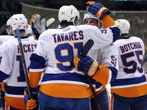 New York Islanders center John Tavares (91) is congratulated by center Casey Cizikas (53) after scoring the game-winning goal against the Toronto Maple Leafs at Air Canada Centre. (Tom Szczerbowski-USA TODAY Sports)