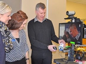 Nicole Janssen (left), a personal support worker with behavioural support and Liz Garant, a registered practical nurse and Behavioural Support Ontario (BSO) lead at the Ritz Lutheran Villa and Mitchell Nursing Home, listen to Pat Shanahan with Envision Consultants, as he describes the Ontario Telemedicine Network (OTN) last Wednesday, March 11 during an open house at the Ritz Lutheran Villa. KRISTINE JEAN/MITCHELL ADVOCATE