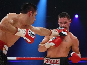 Felix Sturm (left) of Germany punches Daniel Geale of Australia during their WBA and IBF middleweight World Championship fight in Oberhausen, Germany on Sept. 1, 2012. Fellow Australian boxer Braydon Smith died over the weekend following his match against John Moralde of the Philippines. (Ina Fassbender/Reuters/Files)
