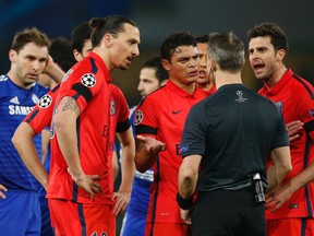 Paris St. Germain's Zlatan Ibrahimovic (left) remonstrates with referee Bjorn Kuipers after being sent off during Champions League play against Chelsea at Stamford Bridge. (Reuters/John Sibley)
