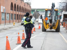 Paid duty Toronto Police officer at a construction site on Lower Sherbourne St. in Toronto on Monday, March 16, 2015. (Ernest Doroszuk/Toronto Sun)