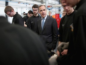The Governor of the Bank of England Mark Carney (C) speaks with apprentices during his visit to the the University of Sheffield Advanced Manufacturing Research Centre (AMRC) in Sheffield, northern England March 12, 2015. REUTERS/Christopher Furlong/pool