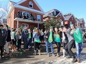 Students on Aberdeen Street in the University District near Queen's University celebrate St. Patrick's Day. Hundreds of young people gathered in the street on Tuesday.  (Ian MacAlpine/The Whig-Standard)