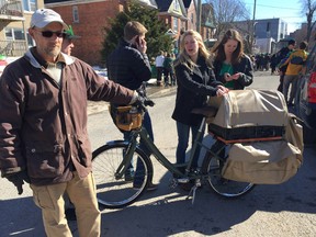 Roy Colquhoun, 49, shows off the bicycle he built specifically for collecting empties, which students on Aberdeen Street were ver interested in. (Alisa Howlett/The Whig-Standard)