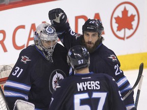 Ondrej Pavelec is congratulated after making 38 saves in the Jets 5-2 win over the San Jose Sharks on Tuesday night.
