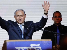 Israeli Prime Minister Benjamin Netanyahu waves to supporters at the party headquarters in Tel Aviv March 18, 2015. Netanyahu claimed victory in Israel's election after exit polls showed he had erased his center-left rivals' lead with a hard rightward shift in which he abandoned a commitment to negotiate a Palestinian state. REUTERS/Amir Cohen