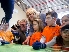 London MPs Ed Holder and Susan Truppe? participate in a science experiment at the London Children's Museum. (DEREK RUTTAN, The London Free Press)