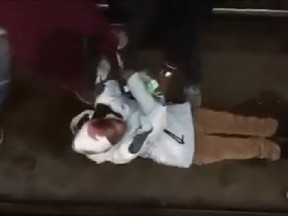 Three young men plucked a bloodied, unconscious woman from Montreal subway tracks in a rescue that was caught on video. (Screenshot from Facebook video)