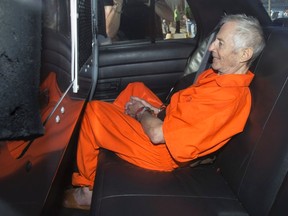 Robert Durst sits in a police vehicle as he leaves a courthouse in New Orleans, Louisiana March 17, 2015.  Durst, scion of one of New York's largest real estate empires, was charged on gun and drug charges, after he was arrested in New Orleans on a murder warrant issued by Los Angeles County Saturday. REUTERS/Lee Celano