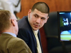 Former New England Patriots football player Aaron Hernandez confers with his attorney Charles Rankin during his murder trial in Fall River, Massachusetts March 13, 2015. (REUTERS/Ted Fitzgerald/Pool)
