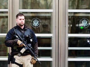 An armed U.S. Marshall stands outside federal court in Brooklyn before the court appearance of Tairod Nathan Webster Pugh, of Neptune, New Jersey, in the borough of Brooklyn in New York March 18, 2015. The U.S. Air Force veteran pleaded not guilty on Wednesday to trying to provide support for the Islamic State militant group. 
REUTERS/Shannon Stapleton