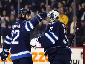 Ondrej Pavelec is congratulated after his 38-save performance against the San Jose Sharks on Tuesday night.