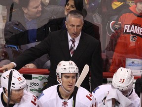 Flames head coach Bob Hartley talks to his players during third period NHL action against the Canucks in Vancouver. on Jan. 10, 2015. (Carmine Marinelli/QMI Agency)