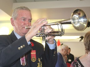 Bob Murray plays The Last Post on his trumpet at the end of a ceremony in Providence Manor honouring him for playing at Remembrance Day services in the area for years. (Michael Lea/The Whig-Standard)