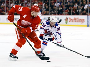 Detroit Red Wings centre Pavel Datsyuk (13) is chased by New York Rangers right winger Mats Zuccarello during NHL play at Joe Louis Arena. (Rick Osentoski/USA TODAY Sports)