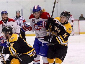 Kingston Voyageurs’ Matt Hoover tries to get between Aurora Tigers Jordan Dasilva, left, and Johnny Curran during Game 2 of the Ontario Junior Hockey League North-East Conference semifinal playoff series at the Invista Centre on Sunday. Game 4 is Thursday at 7 p.m. at the Invista Centre. (Ian MacAlpine/The Whig-Standard)