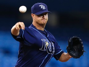 Tampa Bay starter Alex Cobb throws to first  base during MLB play against the Toronto Blue in Toronto Tuesday May 27, 2014. (CRAIG ROBERTSON/QMI Agency)