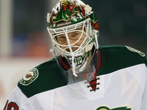 Minnesota Wild goalie Devan Dubnyk watches through his mask during a game against the Calgary Flames at the Scotiabank Saddledome on February 18, 2015. (Al Charest/Calgary Sun/QMI Agency)