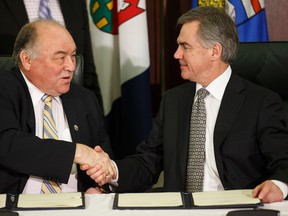 Bob McLeod (left), premier of the Northwest Territories, and Jim Prentice, premier of Alberta sign an Alberta-Northwest Territories bilateral water management agreement at the Alberta Legislature in Edmonton, Alta., on Wednesday, March 18, 2015. The agreement commits both governments to co-operatively manage water resources and focuses on aquatic ecosystems in the Mackenzie River Basin. Ian Kucerak/Edmonton Sun