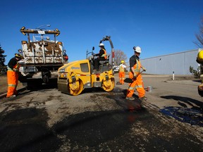 A City of Edmonton roadway crew fill potholes on 182 St.s and 112 Ave., on Wednesday March 18, 2015. "We filled 26,200 potholes in January and February, many of which appeared following the very early arrival of spring-like temperatures in Edmonton." said Bob Dunford, Director of Roadway Maintenance. Tom Braid/Edmonton Sun/QMI Agency