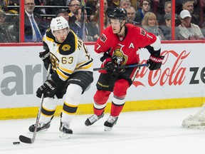 Boston Bruins left wing Brad Marchand (63) skates with the puck in front of Ottawa Senators center Kyle Turris (7) in the first period at the Canadian Tire Centre. Mandatory Credit: Marc DesRosiers-USA TODAY Sports
