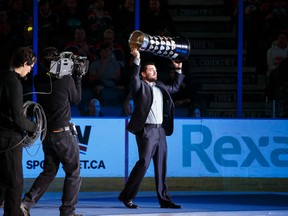 University of Alberta Golden Bears captain Kruise Reddick carries the CIS cup as the CIS University champions are introduced before Wednesday's game between the Oilers and the Blue Jackets at Rexall Place. (Ian Kucerak, Edmonton Sun)
