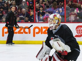 Andrew Hammond is watched by coach Dave Cameron, and thousands of fans, during apre-game skate Thursday that was open to the public at the Canadian Tire Centre. (ERROL McGIHON Ottawa Sun)