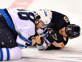 St. Louis Blues centre Steve Ott (9) and Winnipeg Jets centre Eric O'Dell (58) fight during the third period at Scottrade Center March 10, 2015. The St. Louis Blues defeat the Winnipeg Jets 5-4.