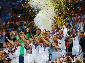 Germany's players lift the World Cup trophy as they celebrate their 2014 World Cup final win against Argentina at the Maracana stadium in Rio de Janeiro, in this July 13, 2014 file photo. (REUTERS/Darren Staples/Files)
