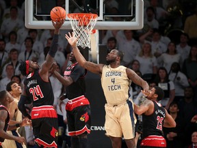Georgia Tech centre Demarco Cox (right) fights for a rebound against Louisville during NCAA action in Atlanta on Feb. 23, 2015. (Jason Getz/USA TODAY Sports)